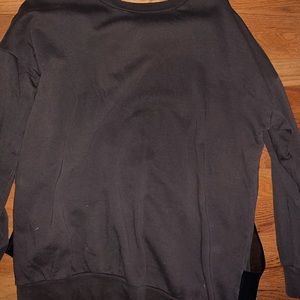 Green sweater with black mesh back.